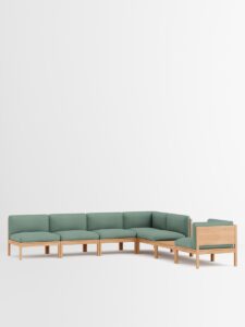 Grünes, modulares Designmöbel‑Sofa im weißen Raum, modernes Interior, nachhaltige Einrichtung aus Hamburg