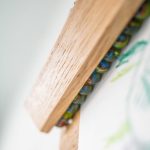 Wooden frame with colorful glass bead necklace in a cozy room